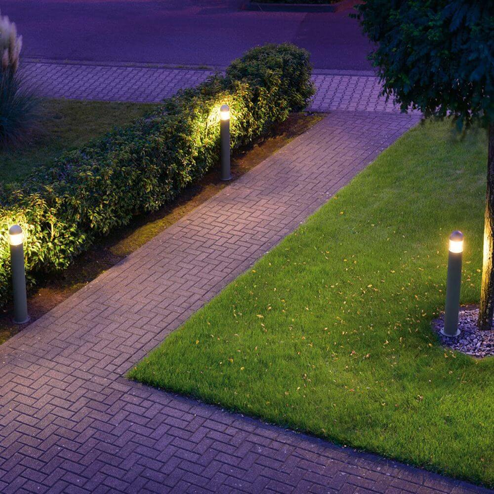 C-POL Stehleuchte anthrazit im Außenbereich, blendfreies Licht entlang einem Pflasterweg.