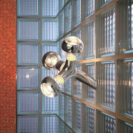 DNA Single-3 wall and ceiling lamp chrome in a modern room with glass block walls.
