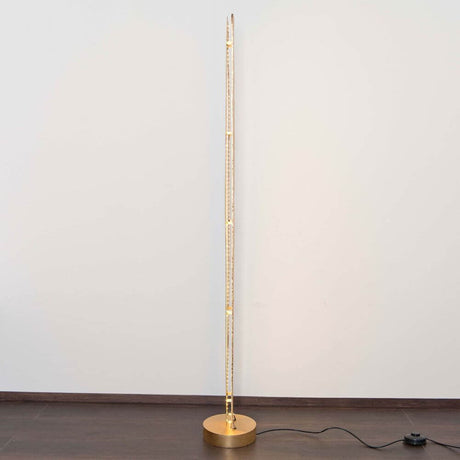 Stehleuchte Simbolo Eisen Braun-Schwarz-Gold in goldener Ausführung auf Holzfußboden.
