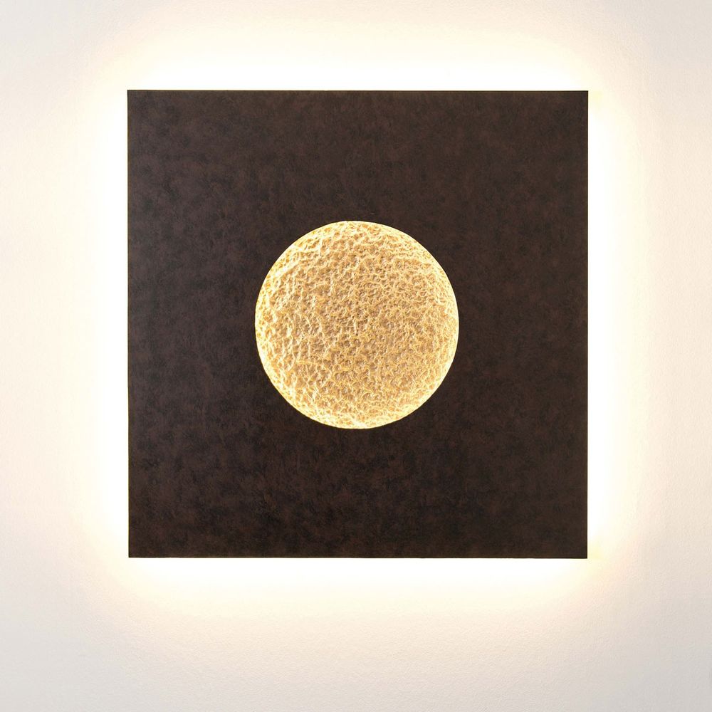 Wandleuchte Luna Quadrat Gross Eisen Braun-Schwarz-Gold auf einer Wand mit sanfter Beleuchtung.
