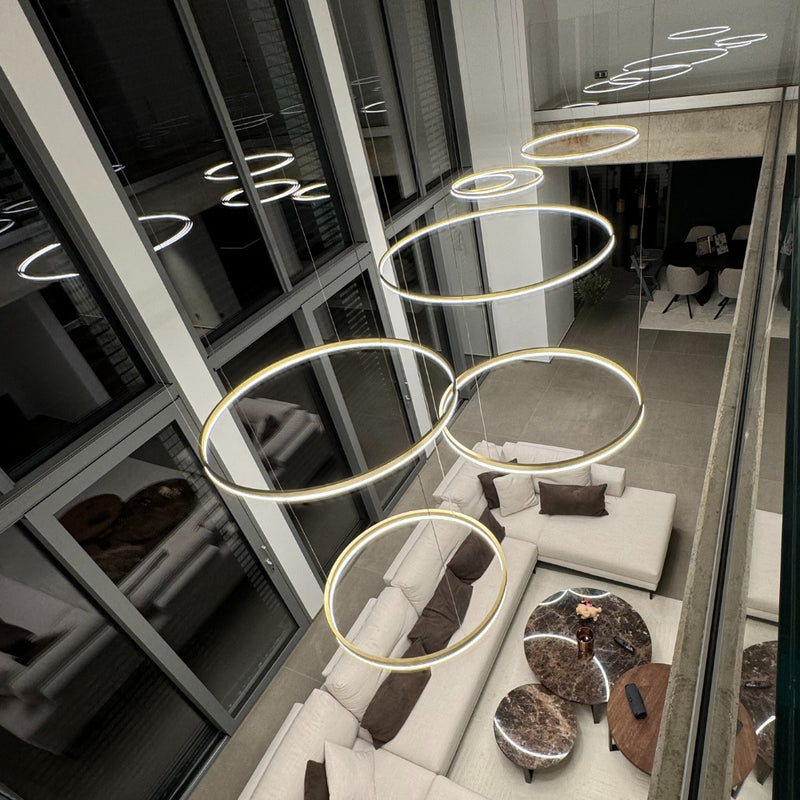 Moderne Leuchten in kreisförmigen Designs über einem stilvollen Wohnbereich. Elegante Einrichtung und zeitgemäßes Ambiente.