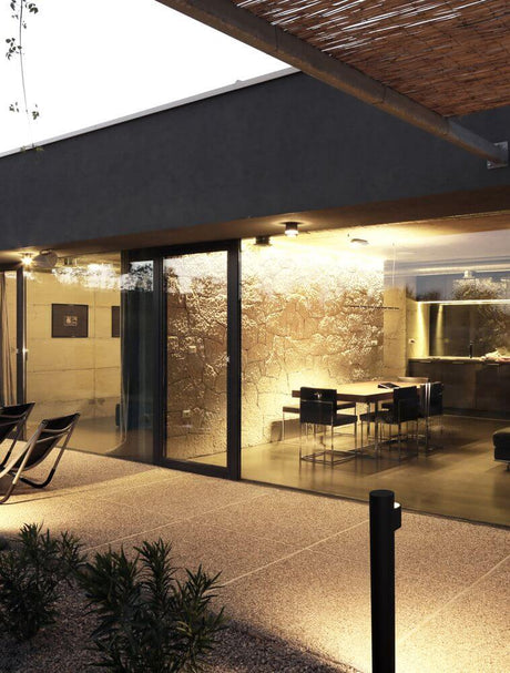 Aduro LED outdoor path light 3000K black IP54 illuminates modern outdoor areas with garden and terrace.