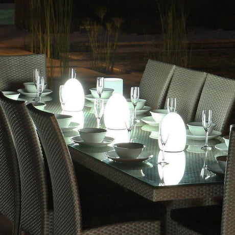 Accu LED tafellamp Egg met app-bediening op een elegante eettafel in het avondlicht.