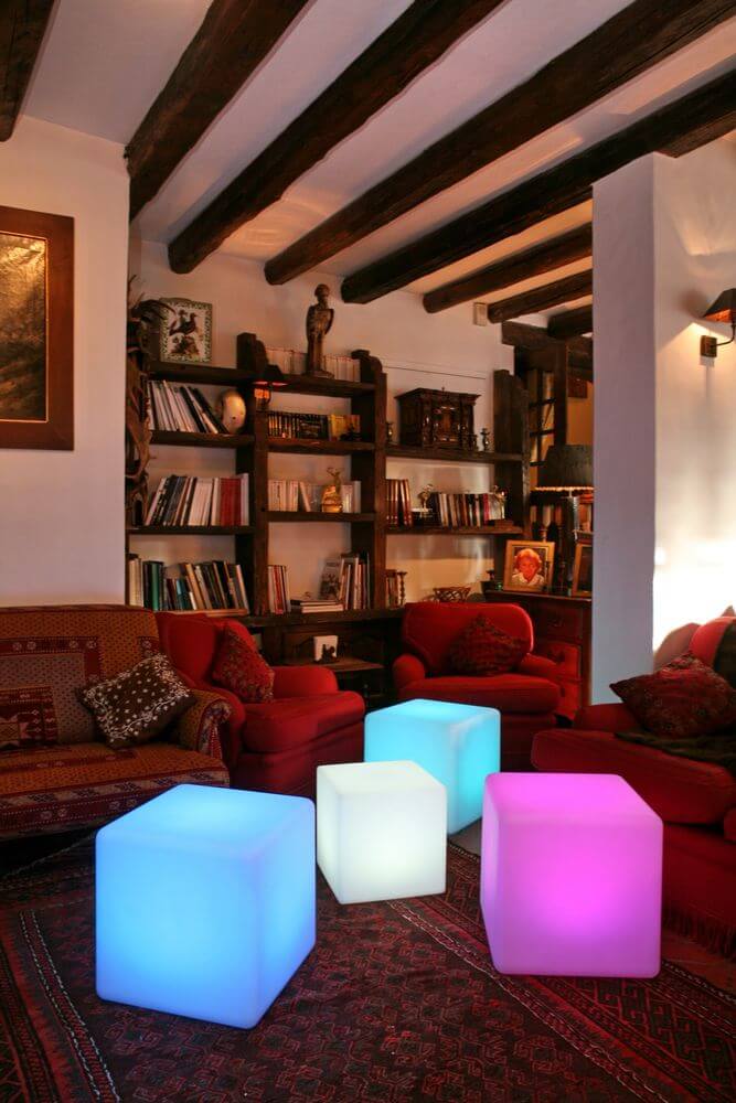 Battery LED Cube 35cm with app control in a stylish living room with cozy furniture.