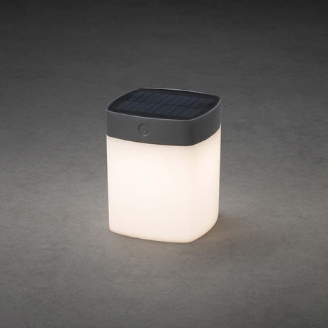 Grey solar LED light Assisi with opal acrylic glass on a dark background.