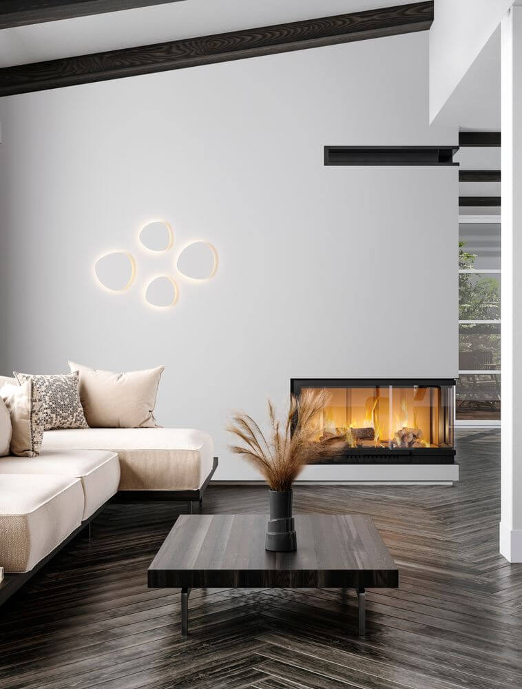 Atena LED Wandleuchte 3000K Weiß in modernem Wohnraum über stilvollem Tisch und Sofa.
