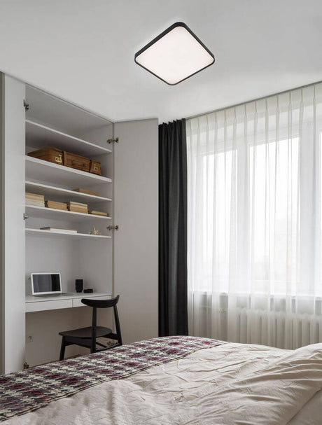 Plafonnier Athos LED 3000K dans une chambre moderne aux couleurs douces et à l’aménagement minimaliste.