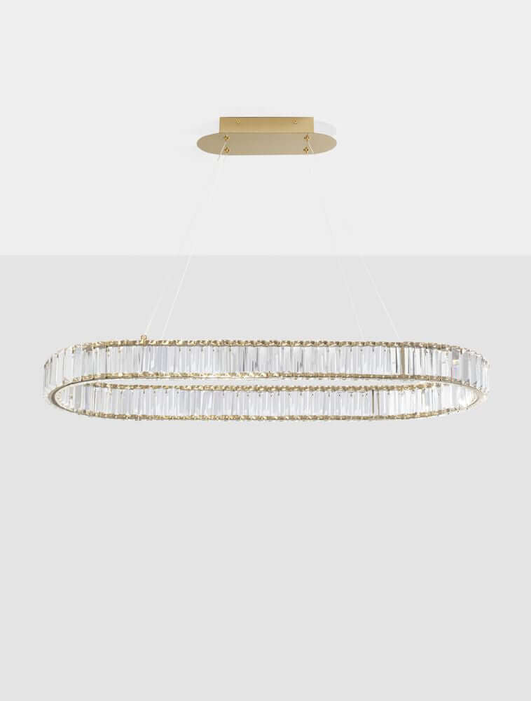 Aurelia LED Pendelleuchte 3500K mit goldfarbenem Metallgestell und massiven Glasstäben, modernes Design.