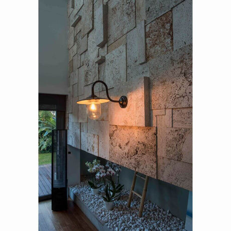 Outdoor wall light HUDSON Black on a stylish wall with decorative stones.