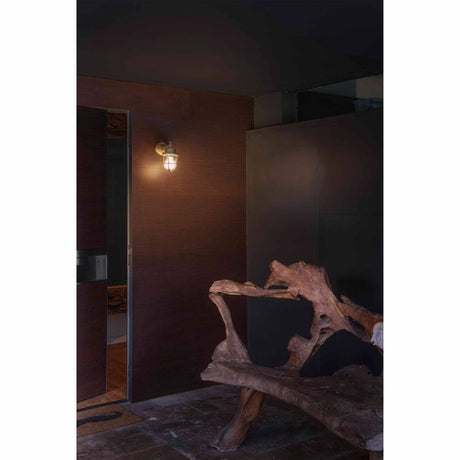 NAHIR outdoor wall light IP44 brass saltwater-resistant in a modern entrance area with wooden bench.