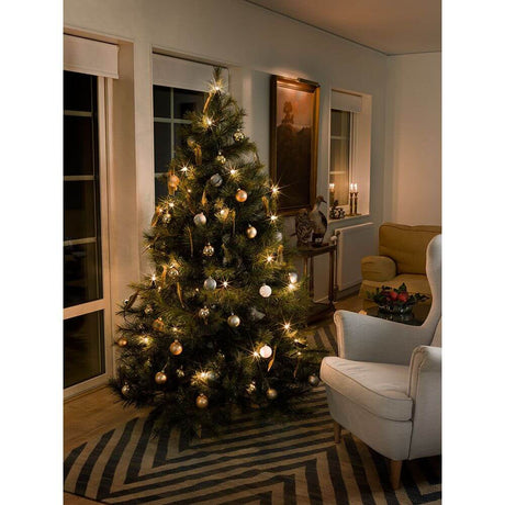 Cozy Christmas tree with tree garland, top bulbs, twisted tip, one string, 30 clear bulbs and gold ornaments.