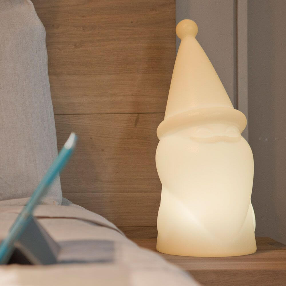 Beleuchteter LED Weihnachtszwerg Amelio als Nachtlampe auf einem Nachttisch, sorgt für festliche Stimmung.