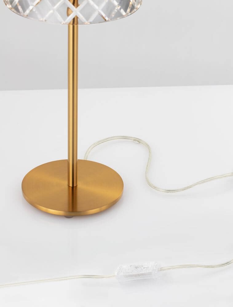 Bion LED Tischleuchte Ø 14,8cm 3000K Gold mit goldener Basis und Kabel auf einem weißen Tisch.