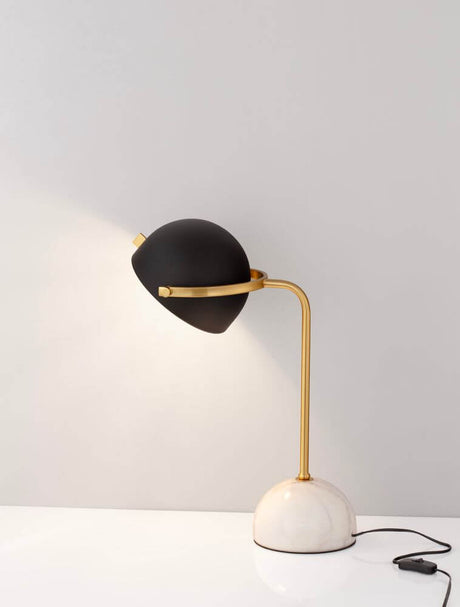 Bishop table lamp White, Gold, Black on a table with a marbled base and black lampshade.