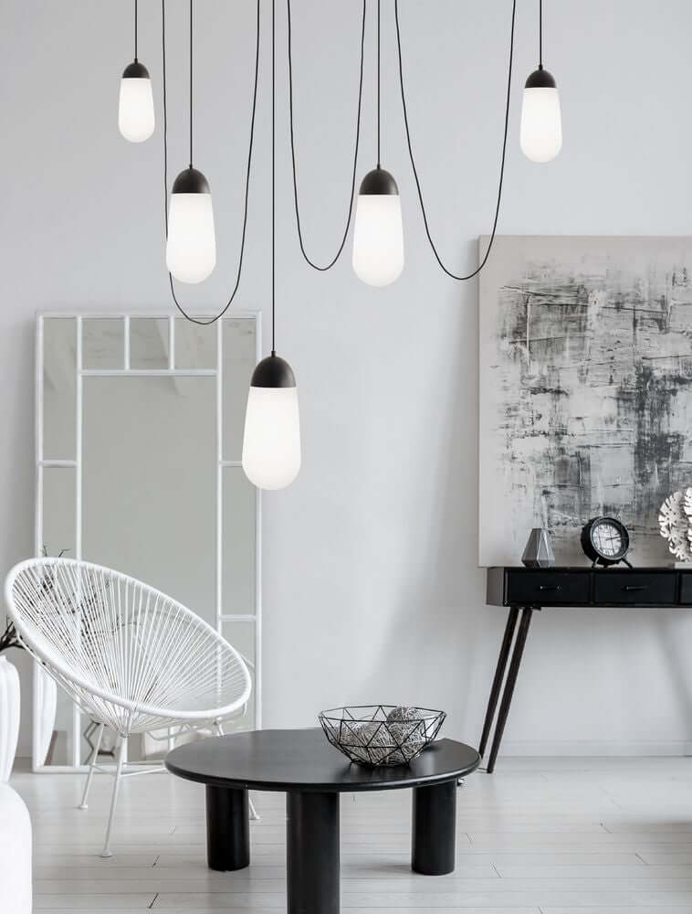 Blaky Pendelleuchte 5-flammig Schwarz, Weiß im modernen Wohnraum mit stilvollem Interieur.