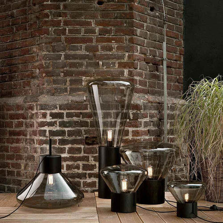 Brokis table lamp Muffins Wood 01 in a modern room with a brick wall and plants.