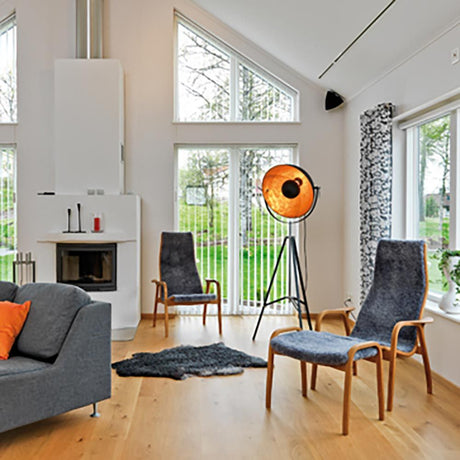 Tripod lamp Captain Black, Gold-coloured in a modern living room with wooden flooring and large windows