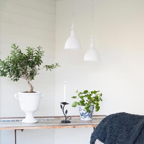 Bazar pendant lamp Ø 17 cm sand white hangs above a table with plants in a modern living setting.