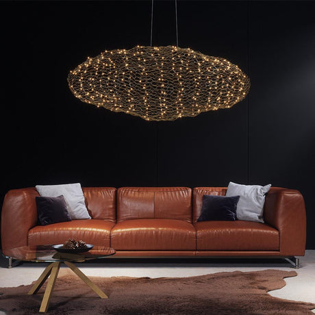 LED-Hayden XL pendant light 115cm gold-colored in a modern living room above a leather sofa.