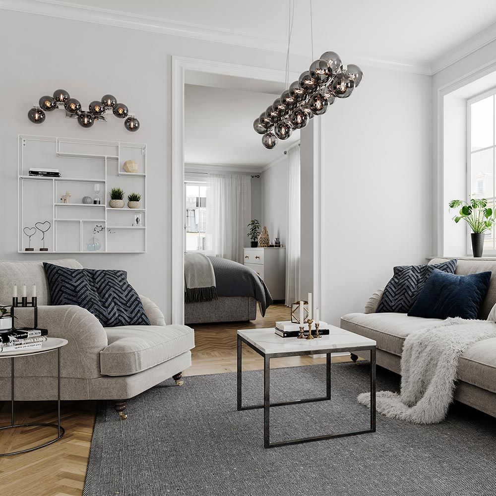 Pendellampe Splendor Bar 124 cm i moderne stue over salongbordet.