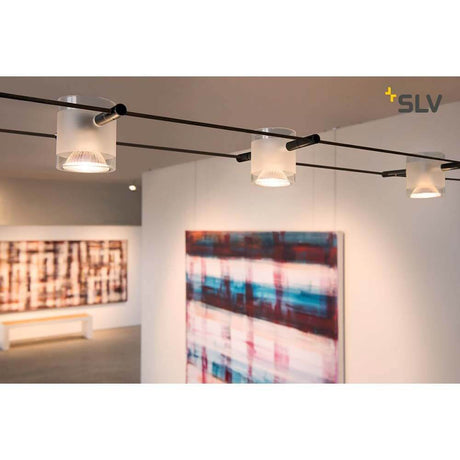 Comet cable light for Tenseo 12V cable system Black in a modern showroom with artworks.