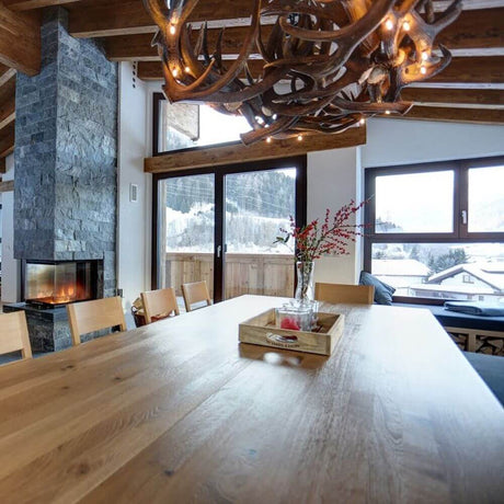 Chalet Rothirsch LED Gevir lysekrone Ø 80 cm i spisepladsen i en moderne hytte i Østrig.