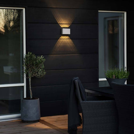 Modern Chieri LED outdoor wall light IP54 on a black exterior wall with atmospheric light design.