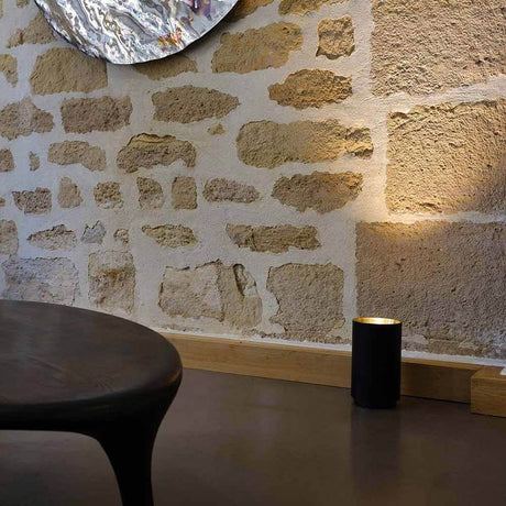 DCWéditions Tobo steel floor lamp Ø 14 cm in modern interior design with warm light.