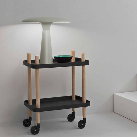Design table lamp Shelter Ø 41 cm limestone on a modern trolley in a minimalist room.