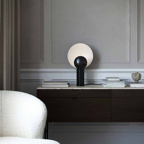 Caché table lamp marble on a sideboard in a modern living room, stylish design with marble base.