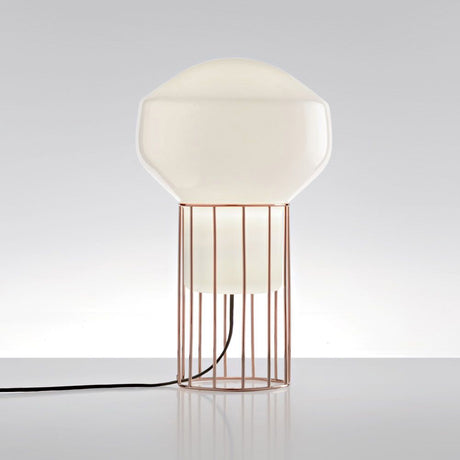 Fabbian Aérostat table lamp Ø 11 cm with a glossy white glass diffuser and frame made of dark grey and brass metal.