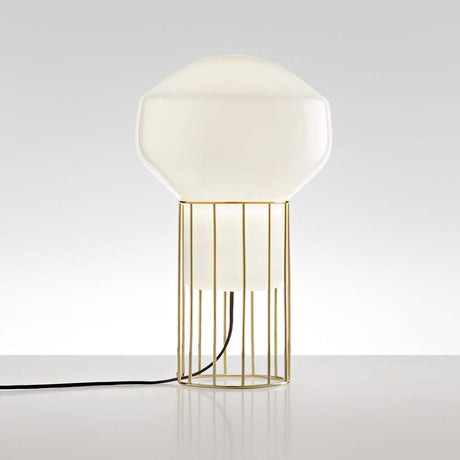Fabbian Aérostat table lamp Ø 11 cm with a glossy glass diffuser and a dark grey and brass metal frame.