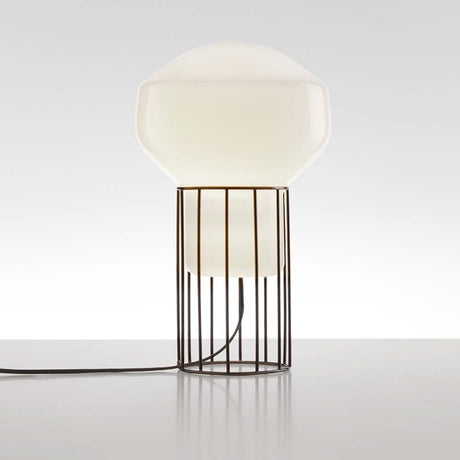 Fabbian Aérostat table lamp Ø 11 cm in a modern design with a white glass diffuser and a dark grey metal frame.