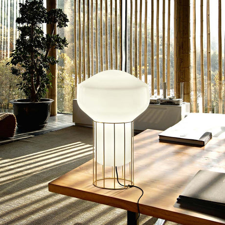 Fabbian Aérostat table lamp Ø 16.7 cm on a table in a modern setting with natural light.