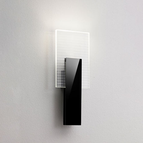 Fabbian Amulette LED wall light with ribbed glass diffuser and black metal frame.