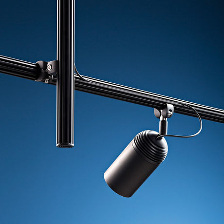 Fabbian Freeline LED track spotlight Ø 6 cm on a black track system in a modern room.