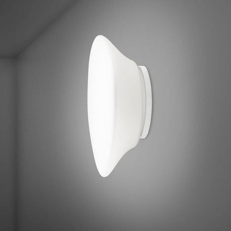 Fabbian Lumi Wandleuchte Mycena Medium an grauer Wand, elegantes Design mit weißem Diffusor aus Glas.