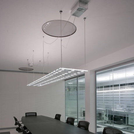 Fabbian Sospesa pendant light 72-light above a conference table in a modern office space.