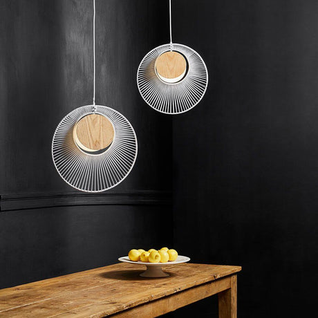 Forestier pendant light Oyster Ø 40cm in an elegant design above a table with a fruit bowl.