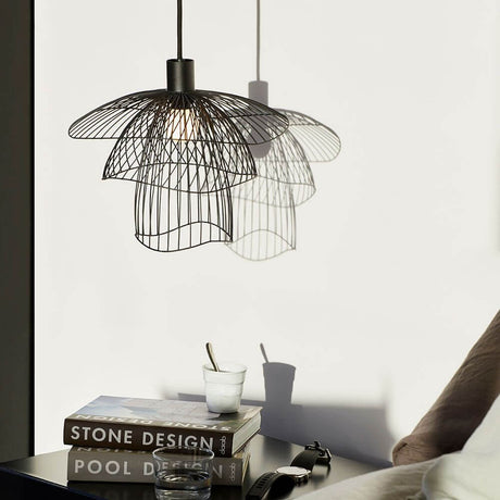 Forestier Papillon pendant light Ø 30cm in a black wire design above a table.