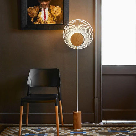 Forestier Oyster floor lamp 145 cm in a modern room with a black chair and artwork on the wall.