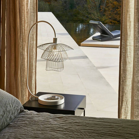 Forestier table lamp Papillon 62cm on a bedside table with modern design and an elegant lampshade.