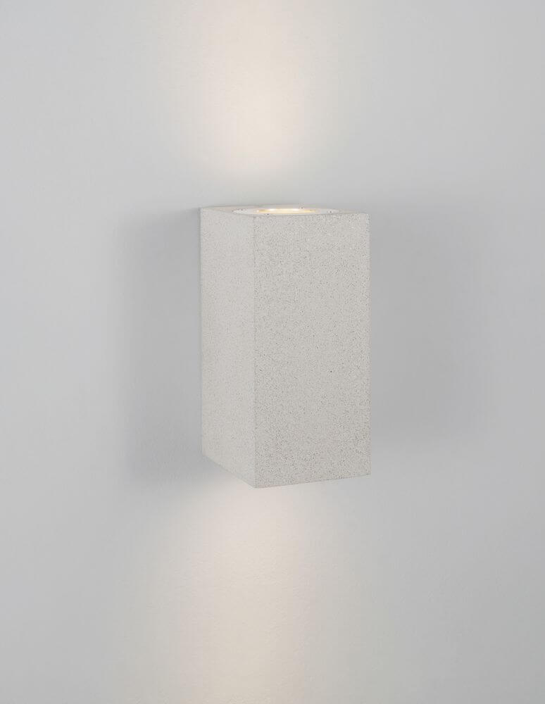 Fuento Außenwandleuchte H 18cm Beton IP65 an einer Wand, modern und elegant aus Beton und Glas.