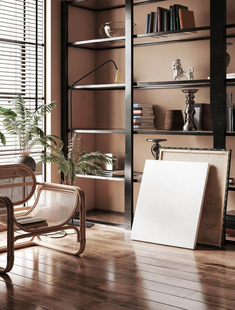 Geko floor lamp black, gold in a modern living room with bookshelf and cosy chair.