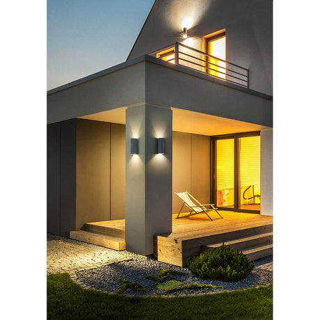 LED Swift outdoor wall light IP65 graphite shining on a modern house, stylish outdoor lighting.