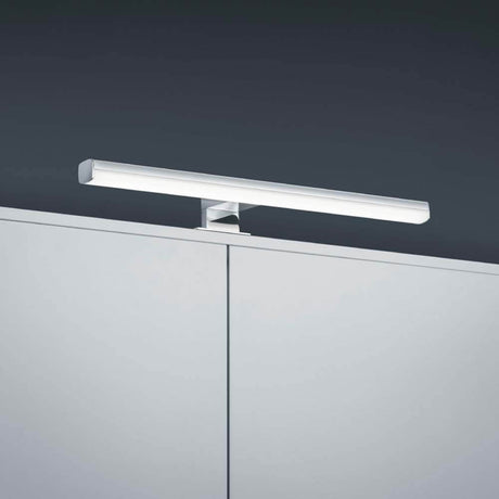 LED Gaia krom væglampe monteret over et møbel, stilrent og moderne design.