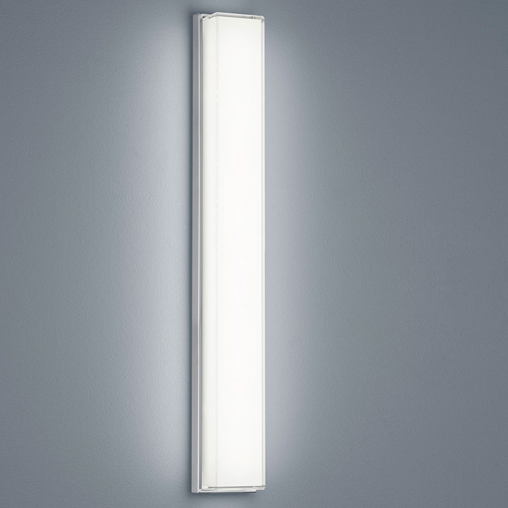 LED Wandleuchte Cosi Nickel-Matt an grauer Wand, dimmbar für individuelle Beleuchtung.