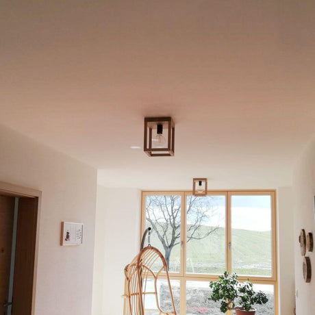 Wood ceiling light, 1-light Kago Oak Oiled Black in a modern room with large windows.