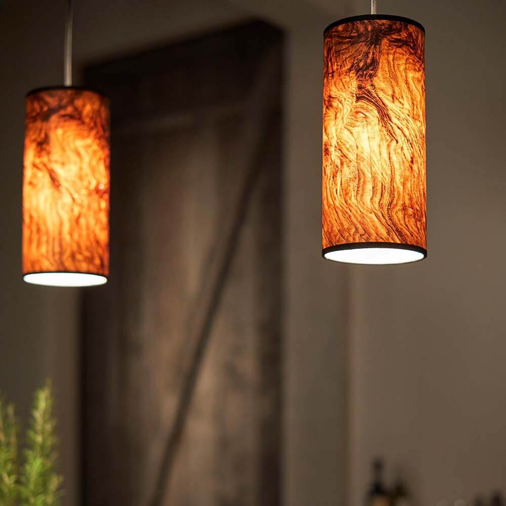 Holz-Hängeleuchte Nux Nussbaum Maser, zylindrischer Schirm aus Echtholzfurnier, stimmungsvolles Licht für entspannte Atmosphäre.