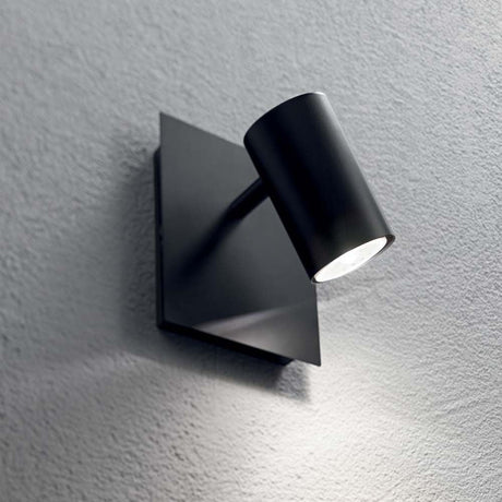 Wall light Spot Ap1 Black mounted on a wall, modern design with a swiveling light head.